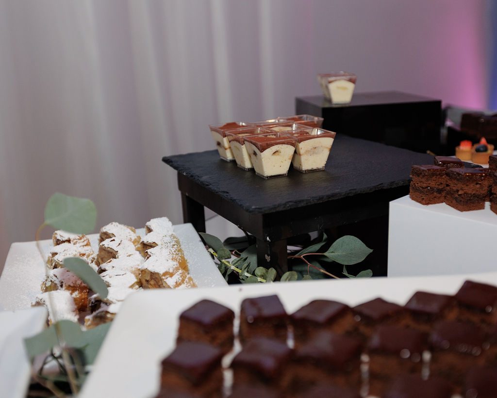 Winter dessert station with individual pots de crème, brownies and pastries at an NYC holiday party