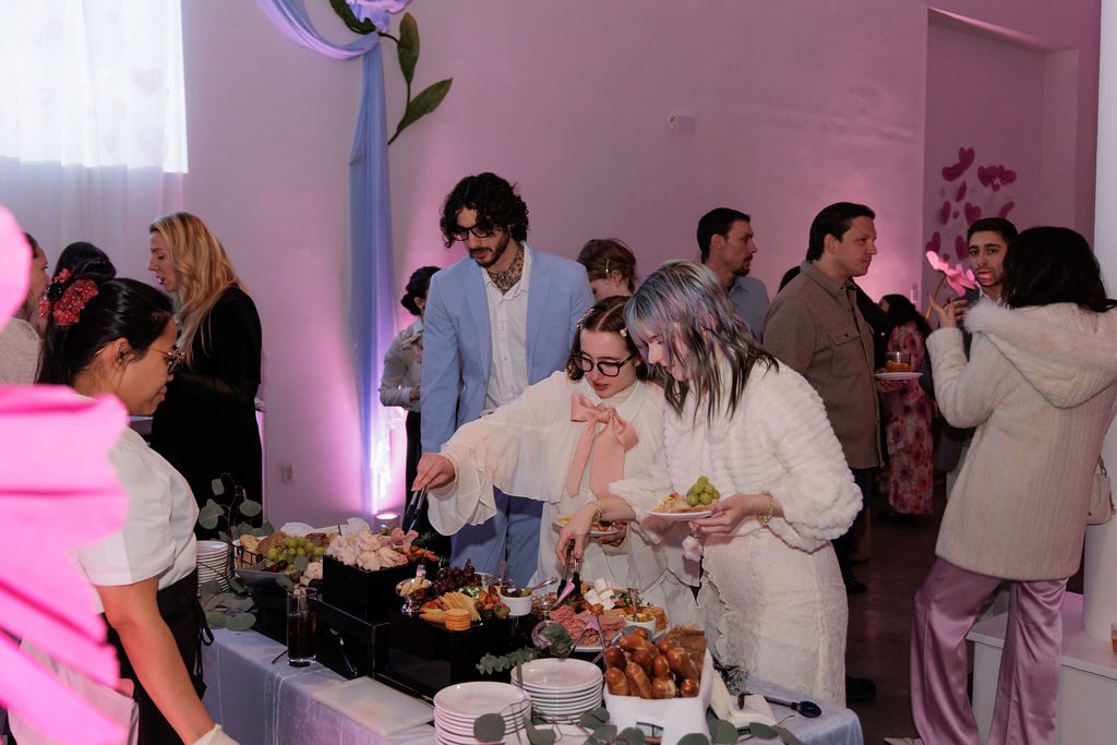 Guests serving themselves at a chef-attended food station during a corporate holiday party in New York City